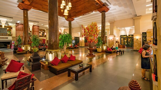 A spacious lobby with a wooden ceiling, comfortable seating areas, and decorative plants. - Angkor Miracle Resort & Spa (Siem Reap)