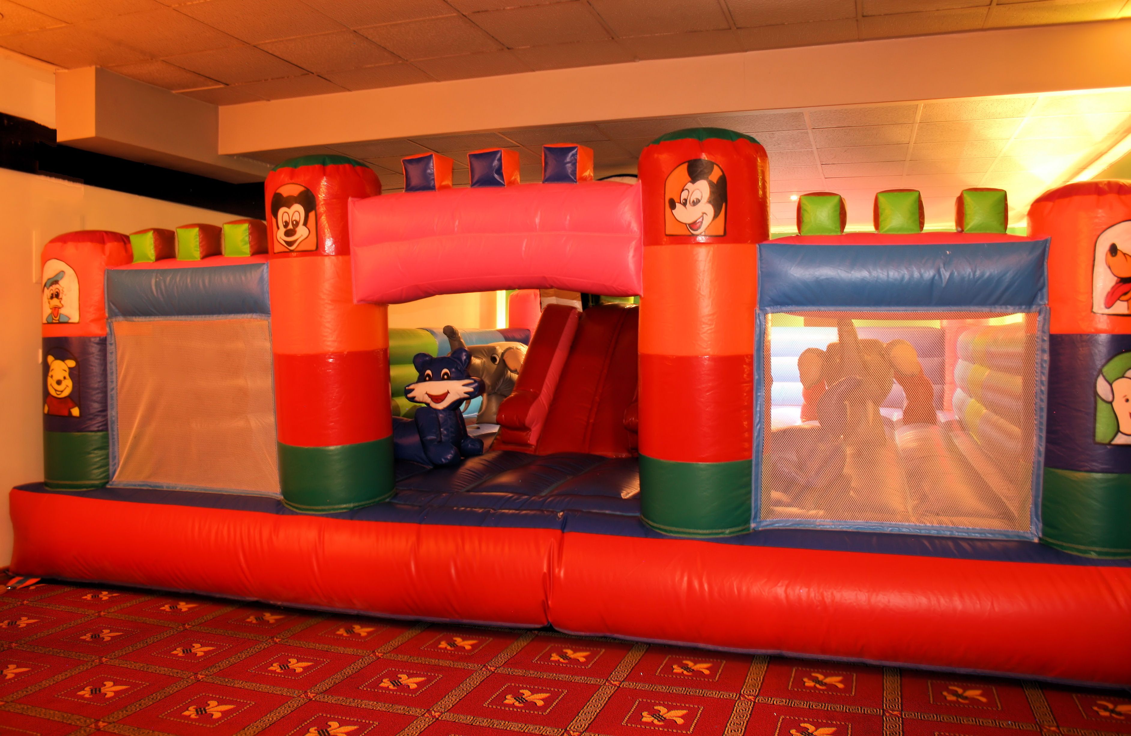 A colorful inflatable play area with cartoon character designs.