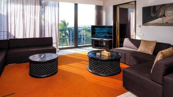 A modern living room with two sofas, a coffee table, and a flat-screen TV.