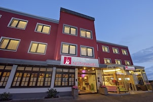 A hotel building with multiple floors, large windows, and a sign indicating it is the Nothnagel Hotel.