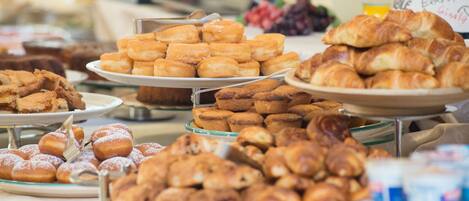 A buffet with various pastries and desserts.