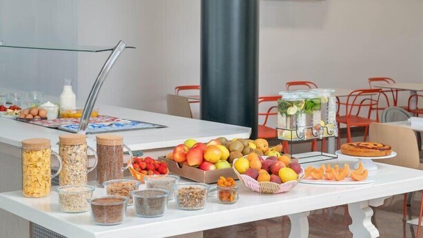 A buffet table with various food items and containers.