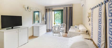 A hotel room with a bed, a desk, a television, and a chair.