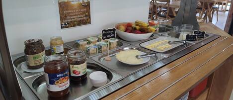 A breakfast buffet with various food items and condiments.