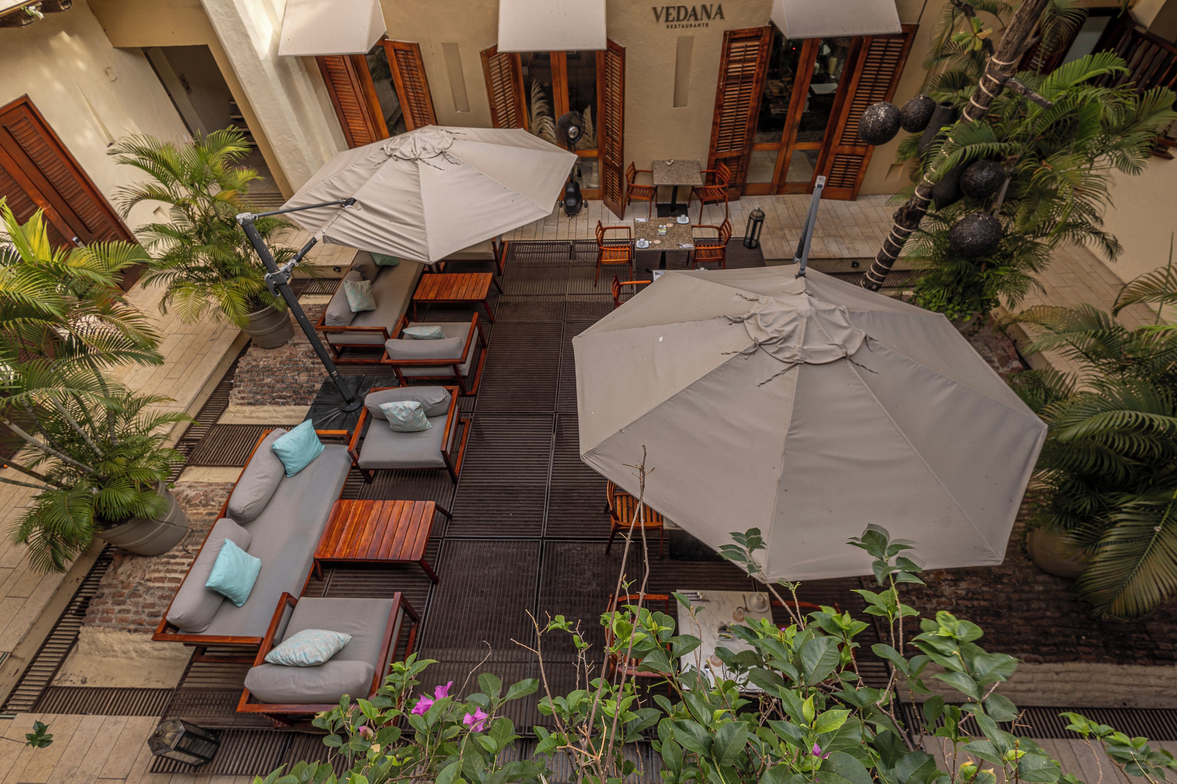 An outdoor seating area with tables, chairs, and umbrellas at a restaurant.