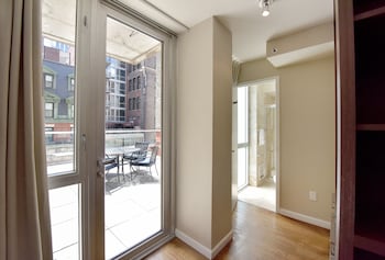 A modern library with leather chairs, bookshelves, and decorative items. at Hotel 32 32