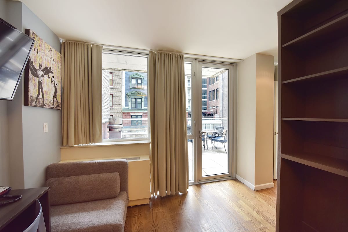 Queen Premier with Roofdeck | Living area | TV, iPod dock