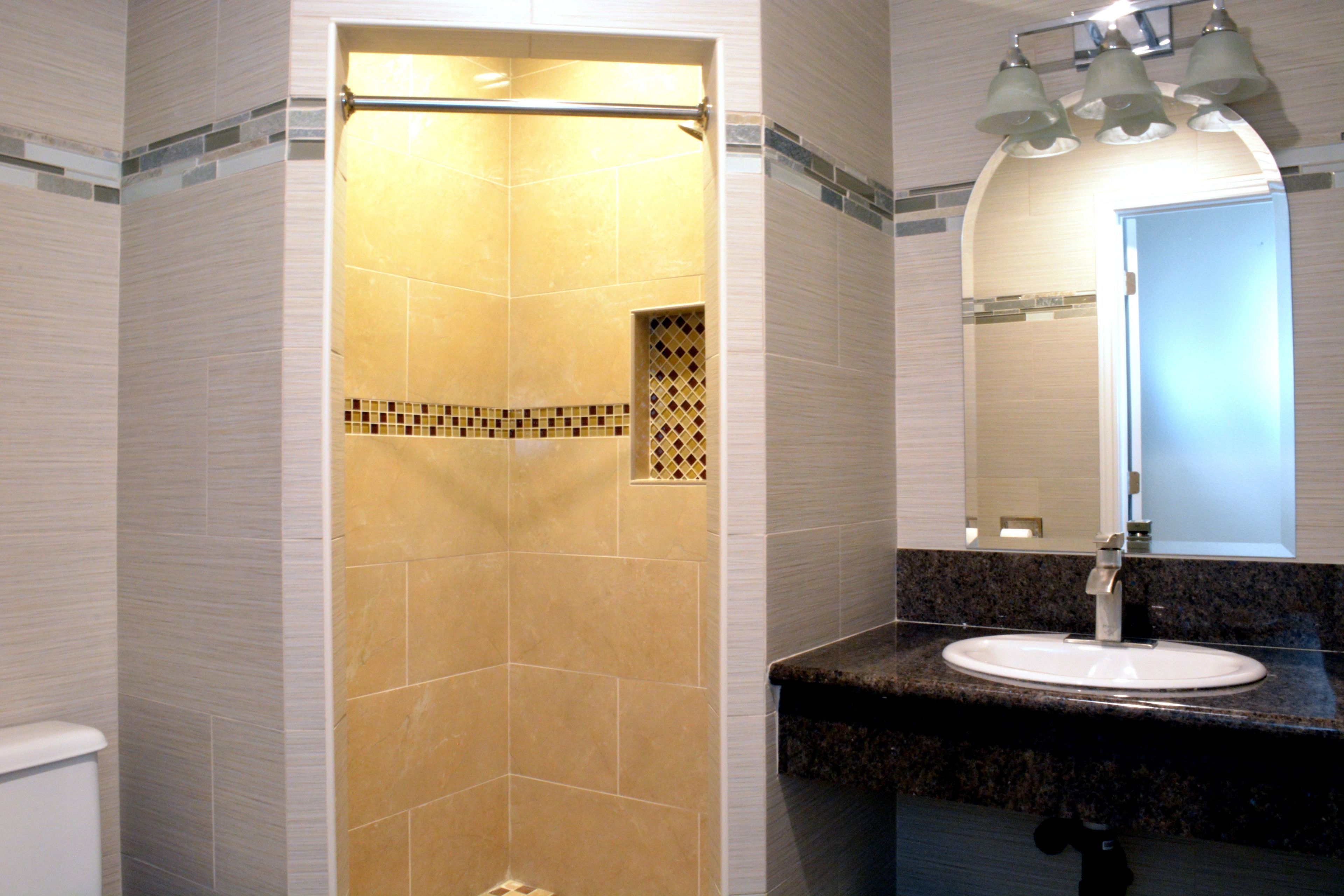 A bathroom with a shower, sink, and vanity.
