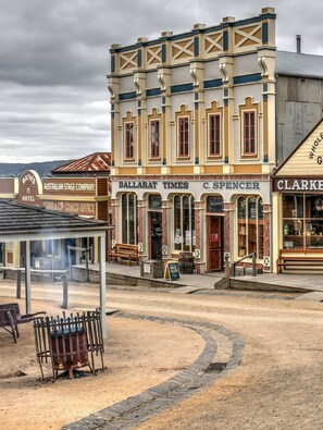A historic building with a central entrance, a sign for 'Ballarat Times', and a 'Coach Office' sign. - Sovereign Hill Hotel (Golden Point (Ballarat))