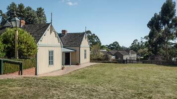A building with a gabled roof and a small porch area.
