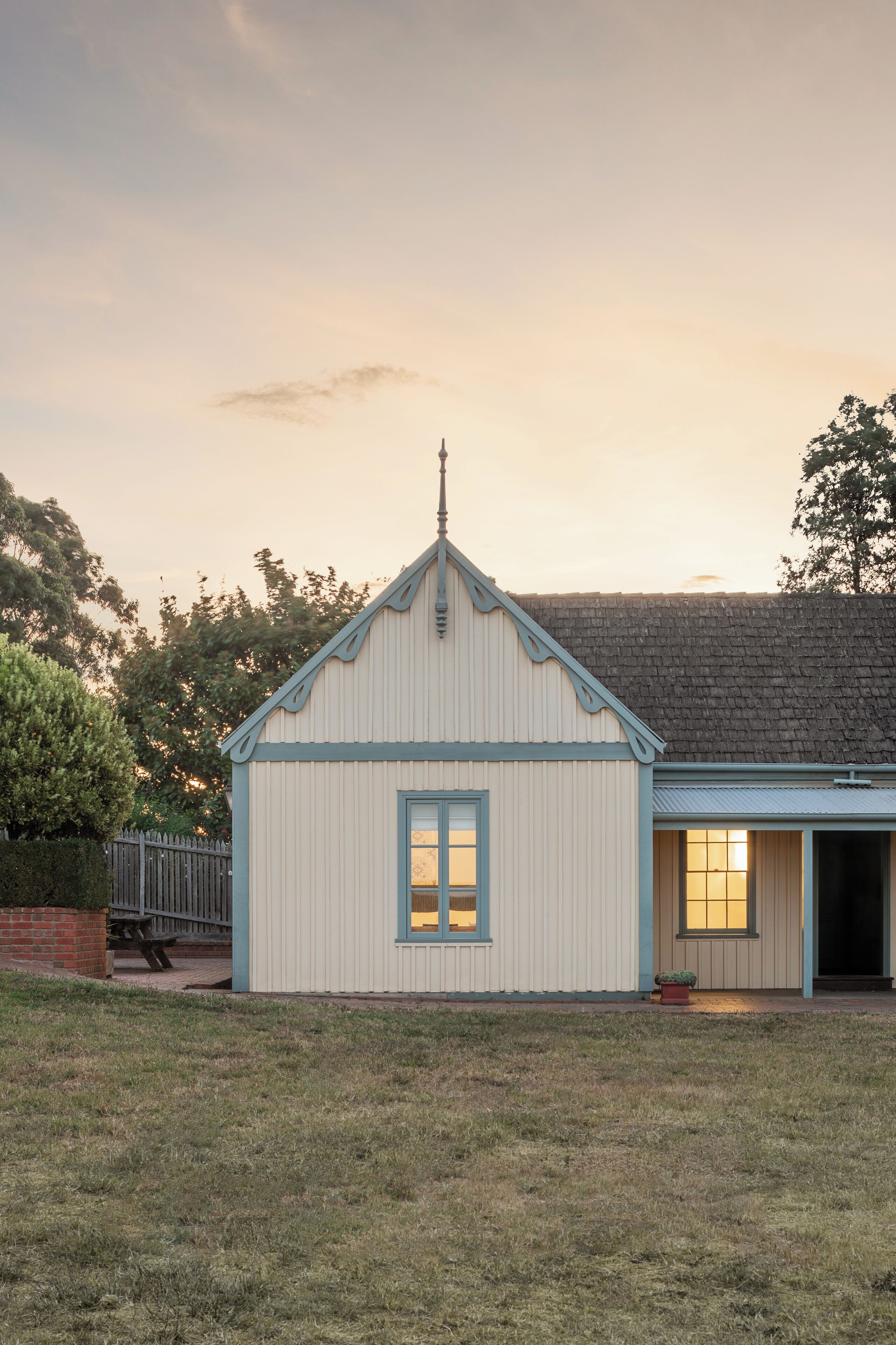 A single-story building with a gabled roof and a small porch.