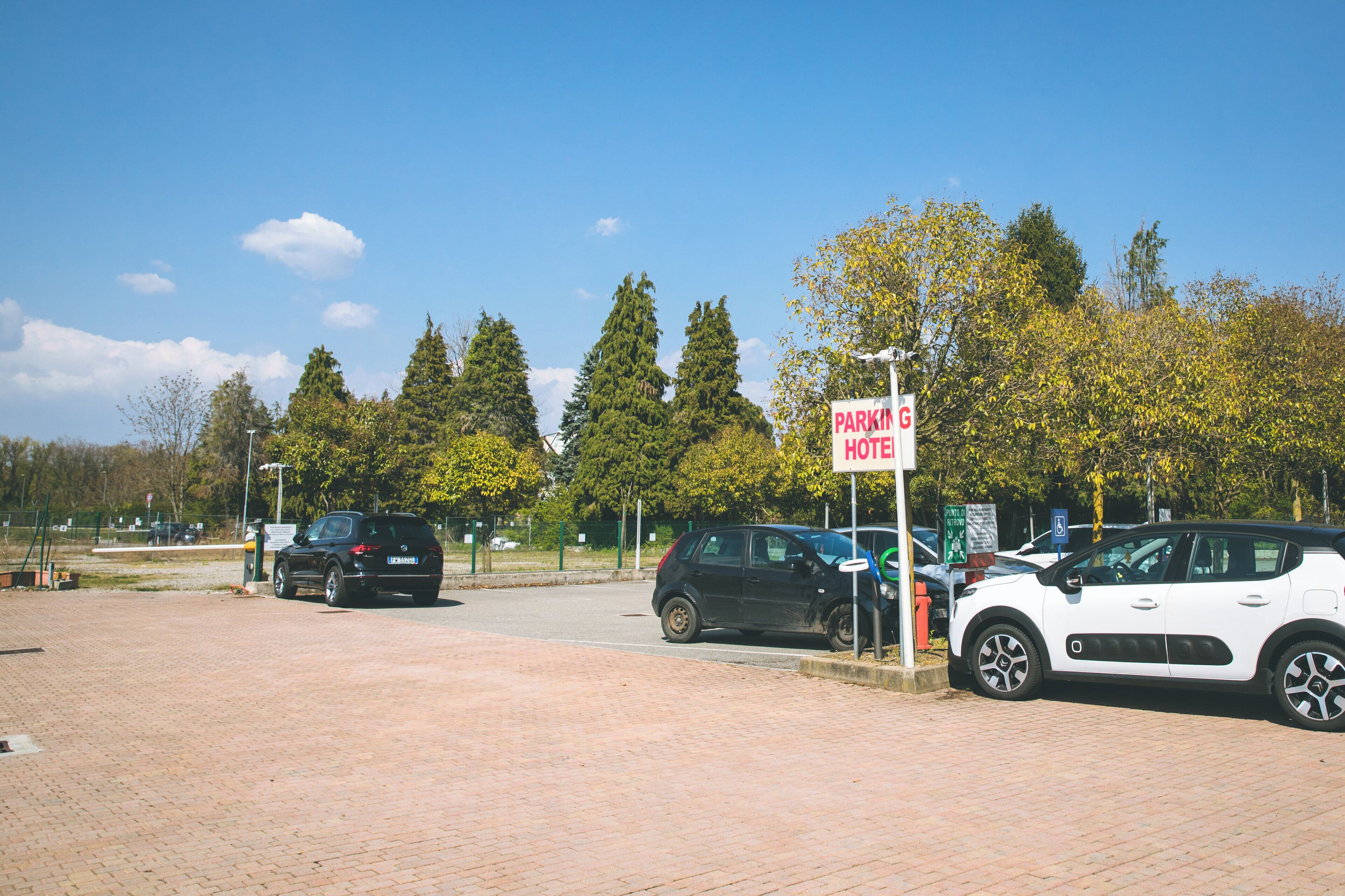 A parking area with a sign for a hotel.