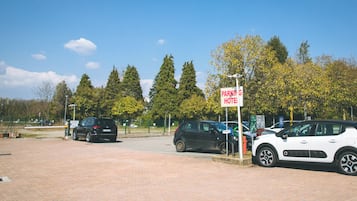 A parking area with a sign for a hotel.