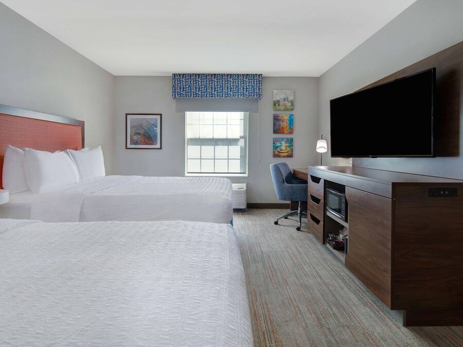 Premium bedding, desk, laptop workspace, blackout drapes