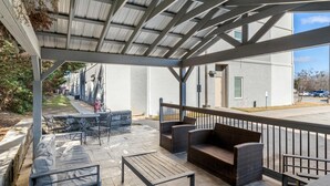 An outdoor patio with seating, a table, and a covered area. - Sleep Inn & Suites Hiram - Atlanta Northwest (Hiram)