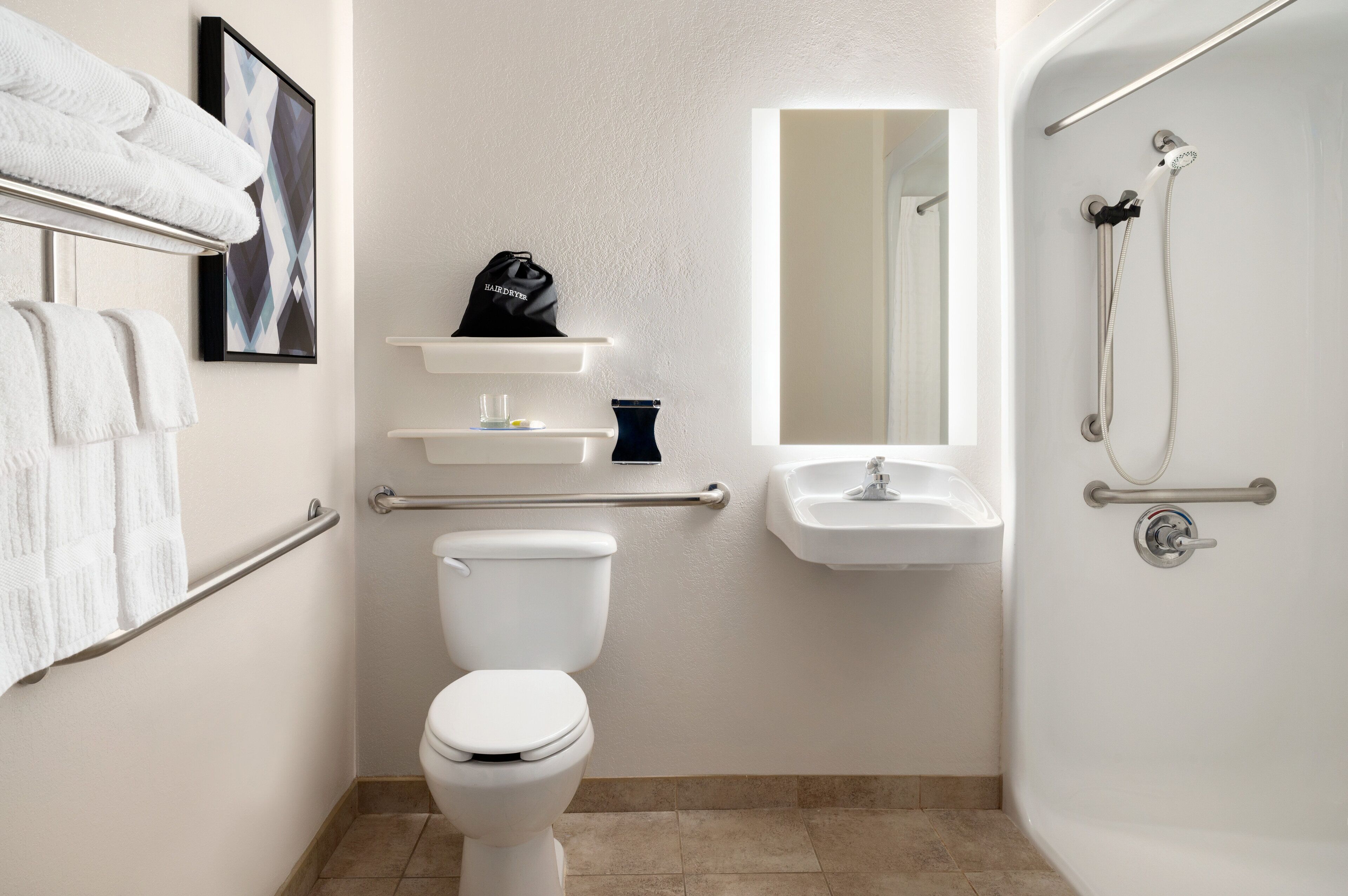 A modern bathroom with a toilet, sink, and shower.