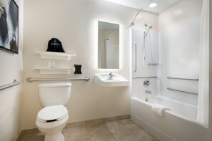 A bathroom with a toilet, sink, and shower. - Candlewood Suites Watertown Fort Drum by IHG (Evans Mills)