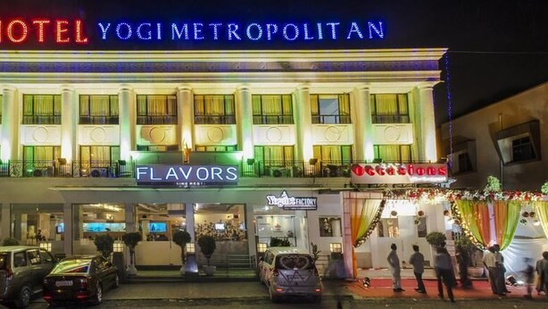 A hotel named 'HOTEL YOGI METROPOLITAN' with 'FLAVORS' and 'Occasions' signage. - Yogi Metropolitan (Navi Mumbai)
