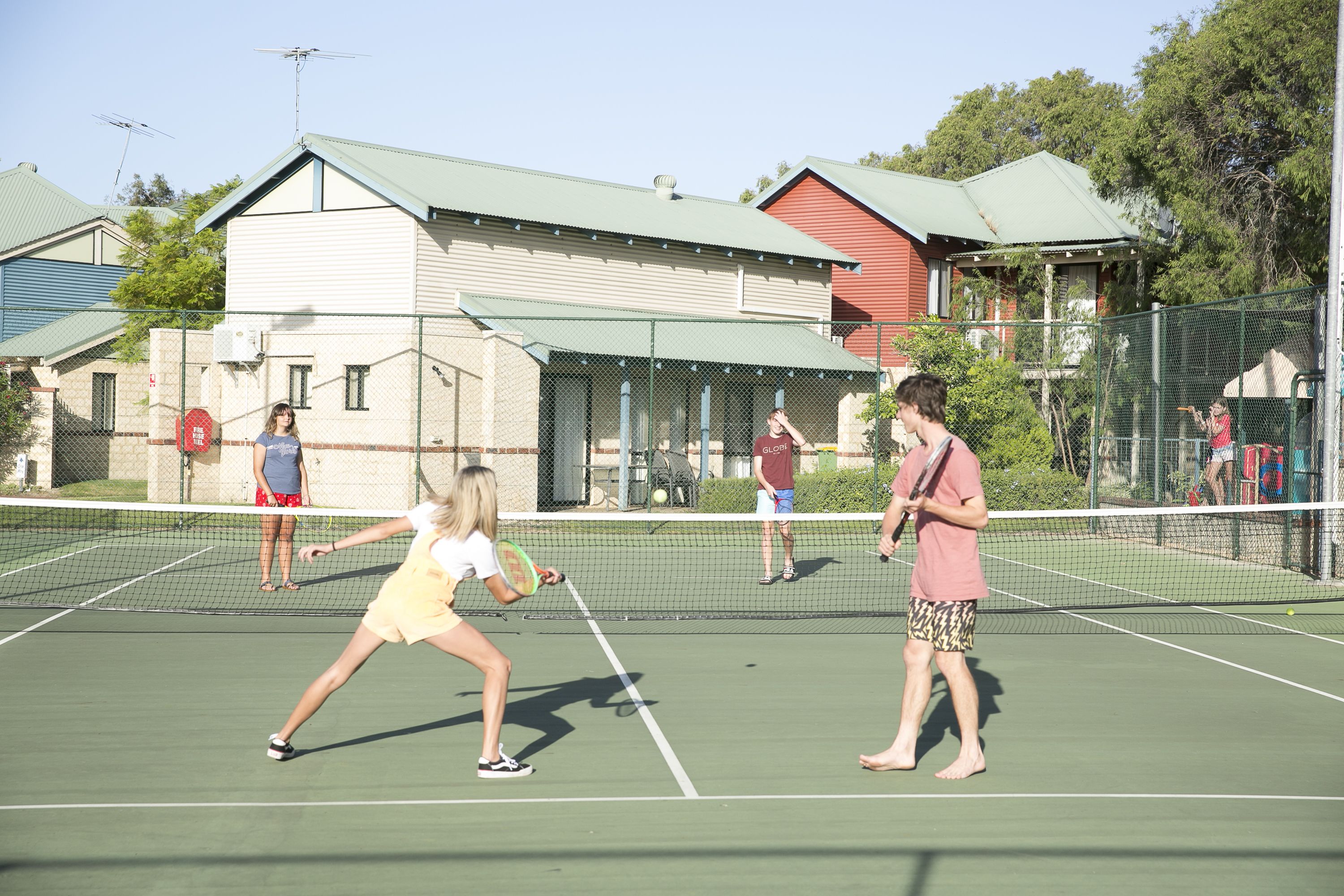 A tennis court with players and spectators.