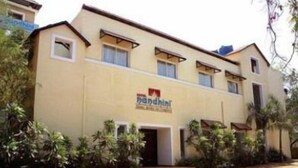 A multi-story hotel with a sign reading "Pandit". - Hotel Nandhini Whitefield (Bengaluru)
