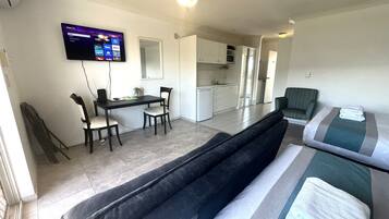 Superior Room, Multiple Beds | Living area | Flat-screen TV