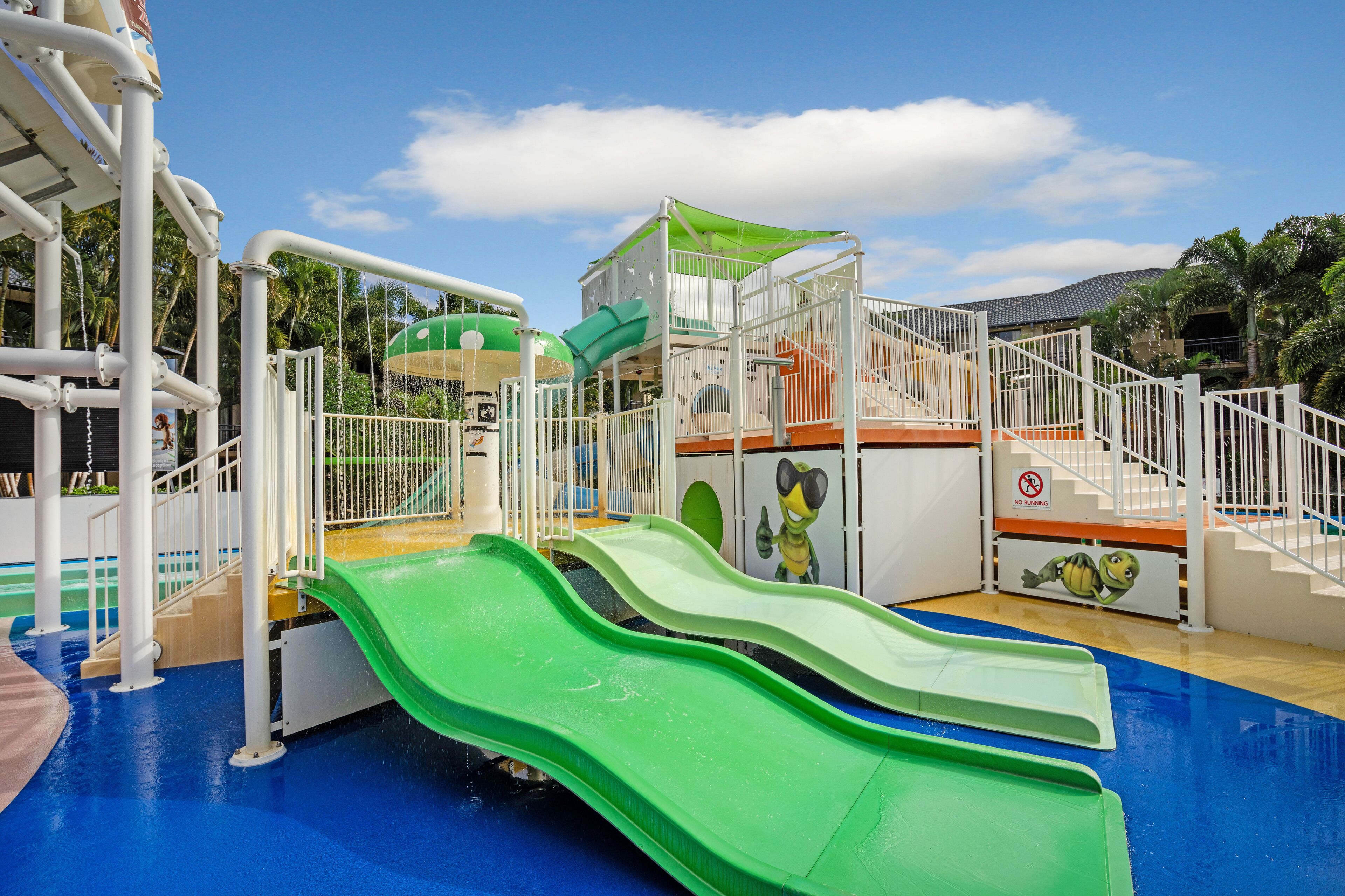 A children's play area with slides and a climbing structure.