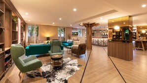 A modern living room with a sofa, armchairs, a coffee table, and a wooden cabinet. - Kyriad Chambéry Centre - Curial (Chambery)
