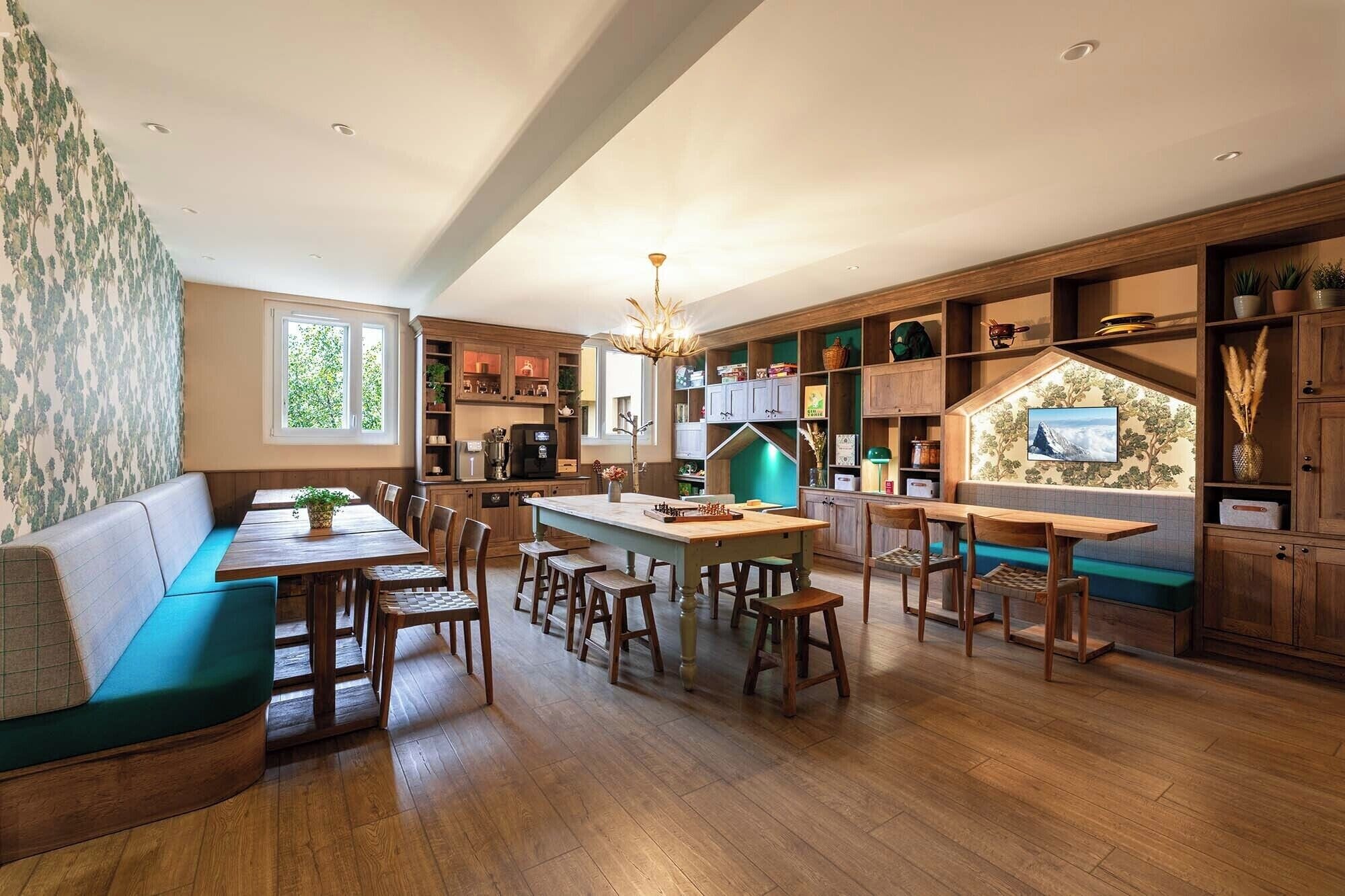 A spacious kitchen with wooden cabinets, a dining area with a long table and benches, and a cozy seating area with a sofa.