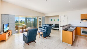 A modern apartment with a living room, dining area, and kitchen. - Lennox Beach Resort (Lennox Head)