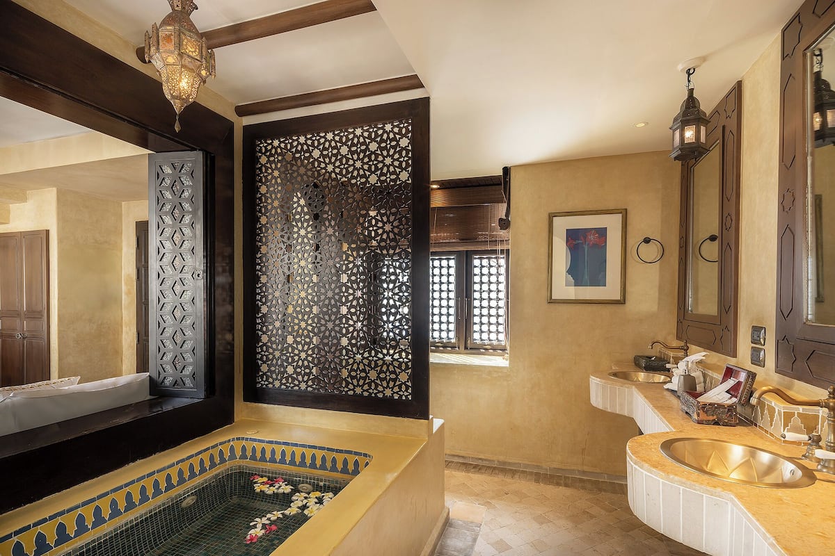 deluxe courtyard | bathroom | rainfall showerhead, designer toiletries, hair dryer, bathrobes
