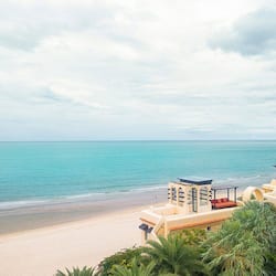 On the beach, white sand, beach umbrellas, beach towels