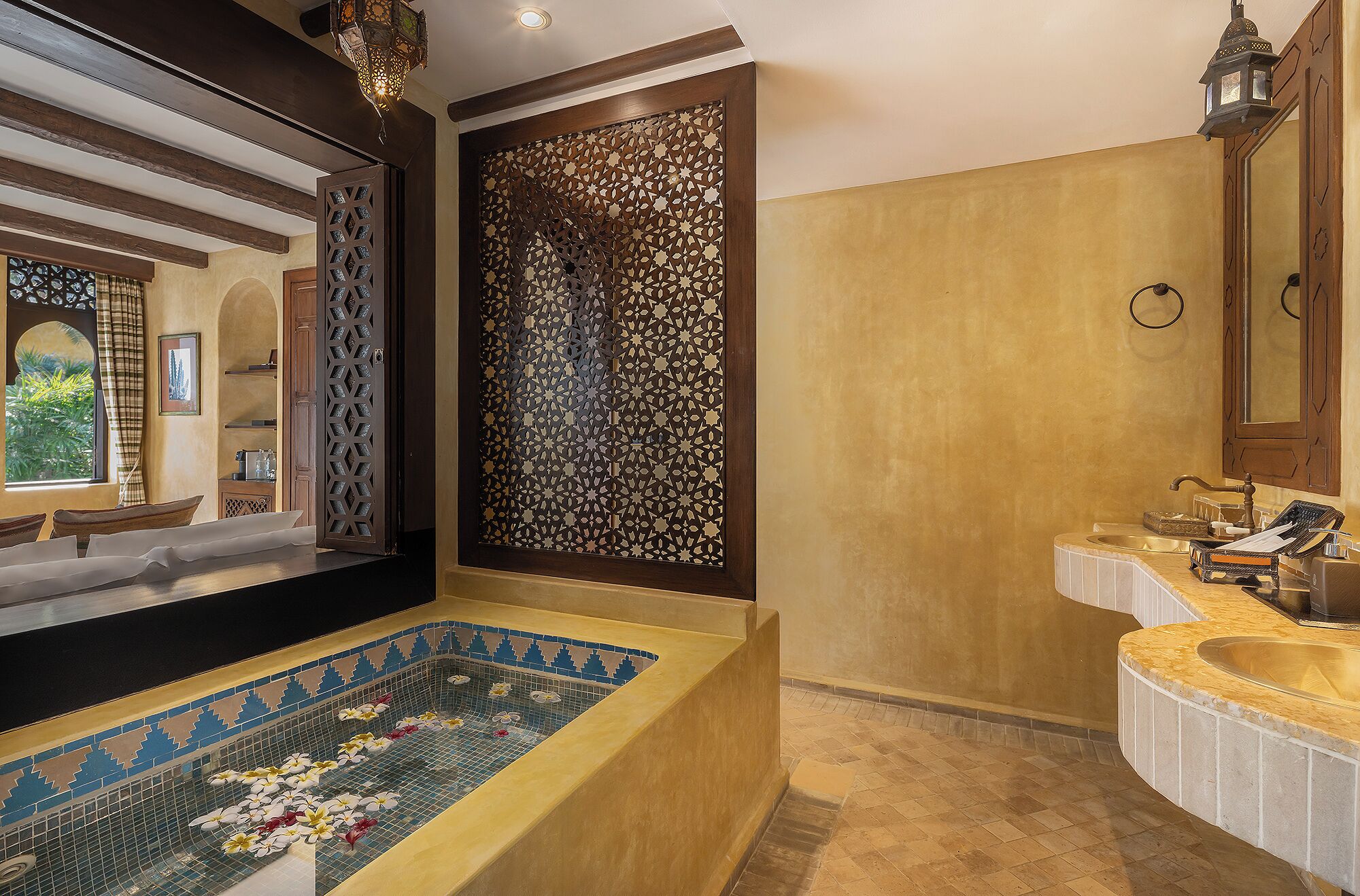 deluxe courtyard | bathroom | rainfall showerhead, designer toiletries, hair dryer, bathrobes