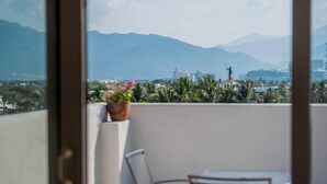 A balcony with a view of mountains, a statue, and a cruise ship. - Comfort Inn Puerto Vallarta Golfside & Marina (Puerto Vallarta)