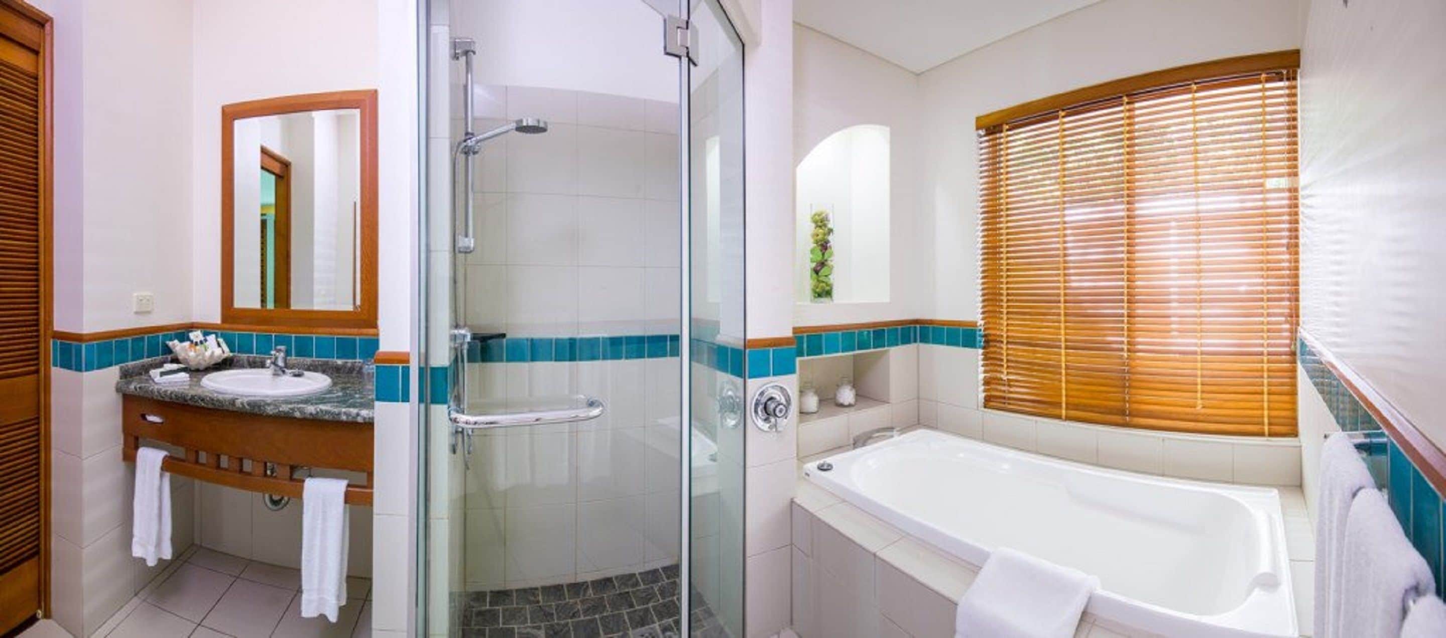 reef suite room | bathroom | separate bathtub and shower, eco-friendly toiletries, hair dryer, towels