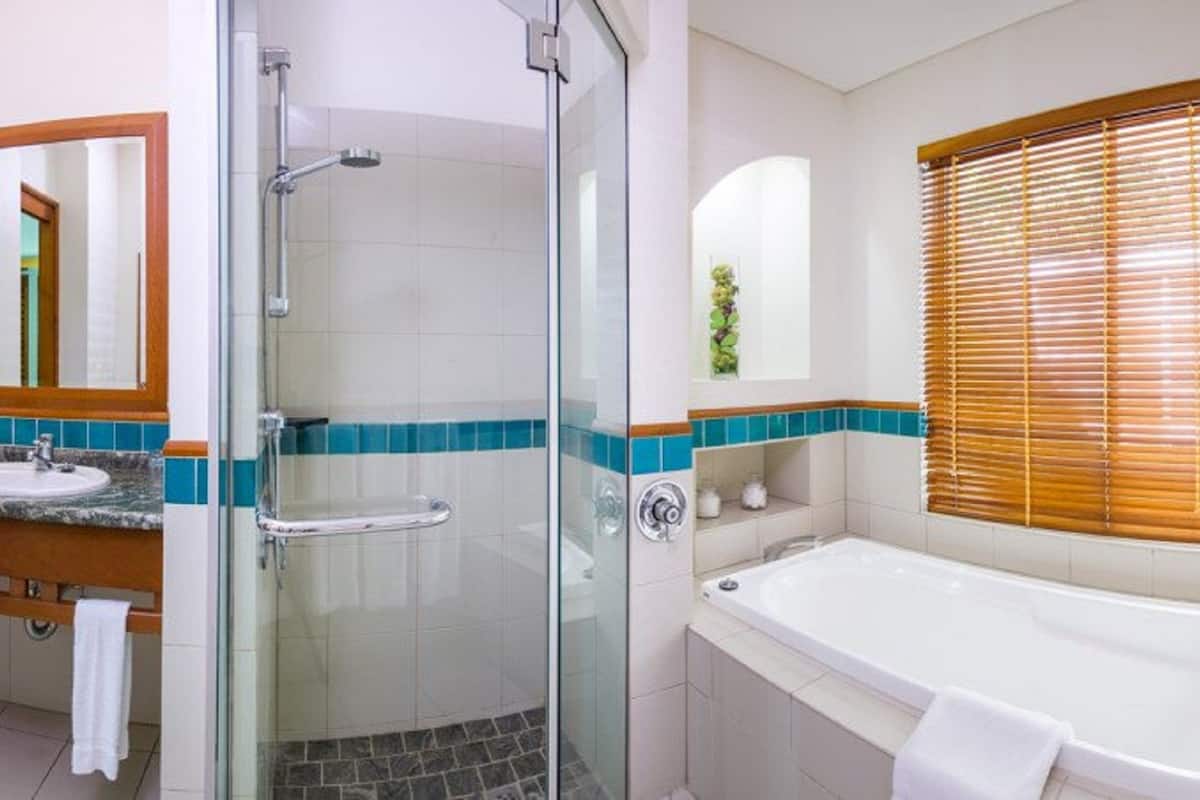 reef suite room | bathroom | separate bathtub and shower, eco-friendly toiletries, hair dryer, towels
