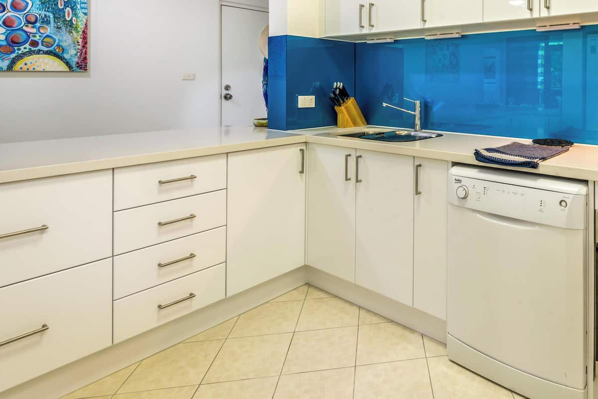 A modern kitchen with white cabinets, a Bosch dishwasher, and an oven.