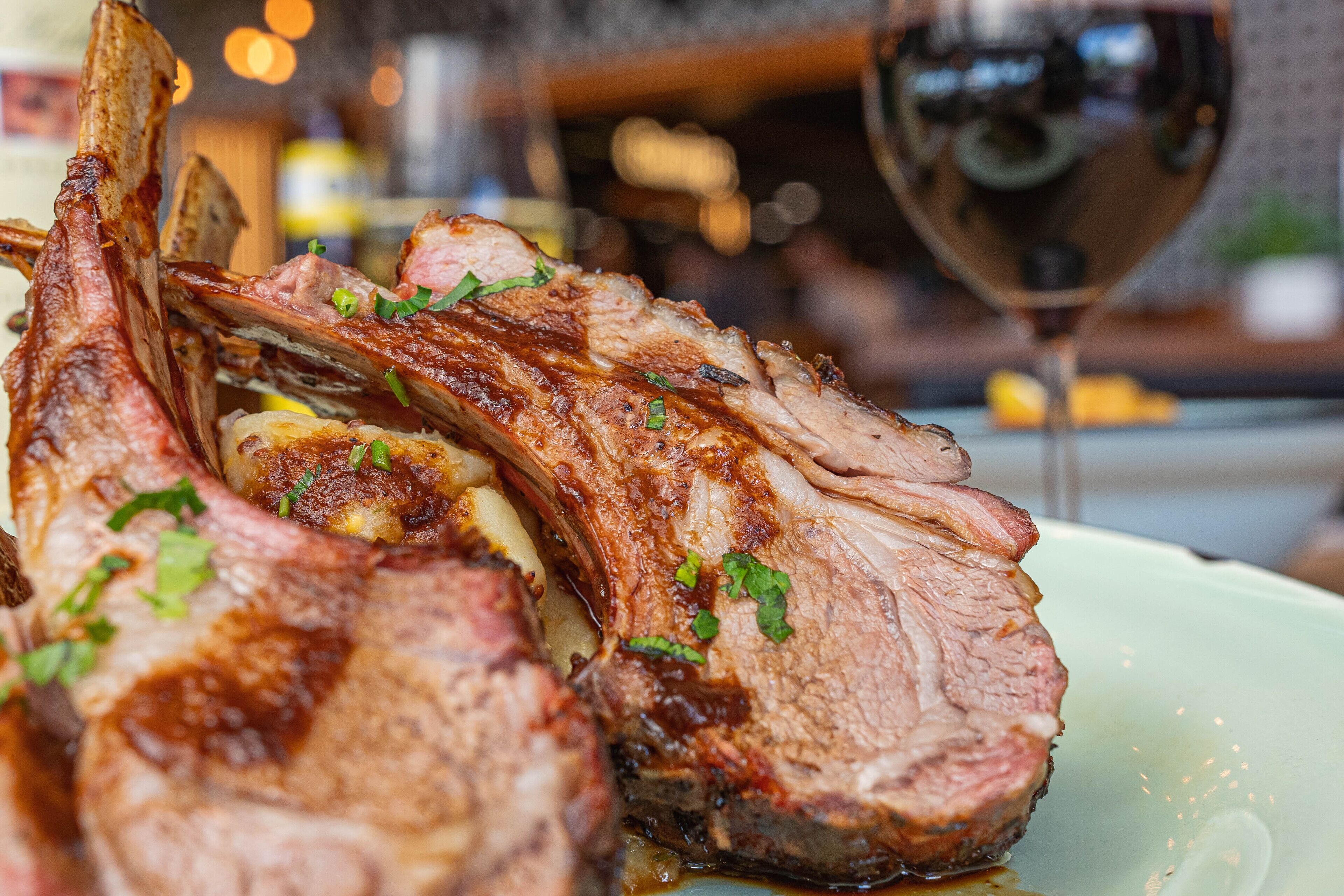 A plate of cooked lamb chops garnished with herbs.