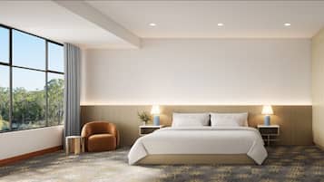 A modern hotel room with a large bed, a sitting area, a bathroom, and a view of the outdoors.