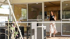 A modern outdoor seating area with wicker furniture and a glass enclosure. - Lily Lagoon Resort (Kununurra)