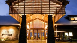 A hotel entrance with a covered lobby, a sign reading "Silverwater Resort," and a golf cart parked outside.