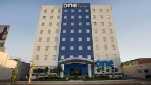 A hotel with a prominent 'one hotel' sign, a modern facade, and a clear entrance area.