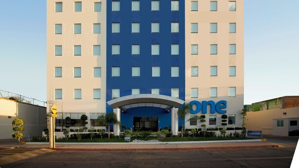 A hotel with a modern design, featuring a prominent 'one hotel' sign at the top.