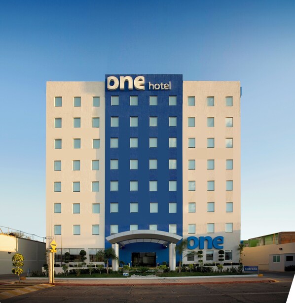 A hotel with a modern design, featuring a prominent 'one hotel' sign at the top.