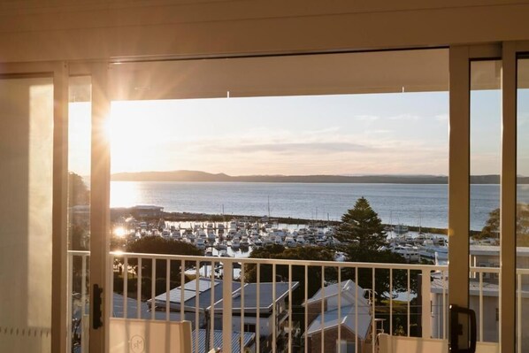 A balcony with a view of a marina and the ocean. - Marina Resort - Adults Only (Nelson Bay)