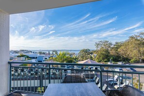 A balcony with a view of a parking lot and trees. - The Landmark Resort Nelson Bay (Nelson Bay)