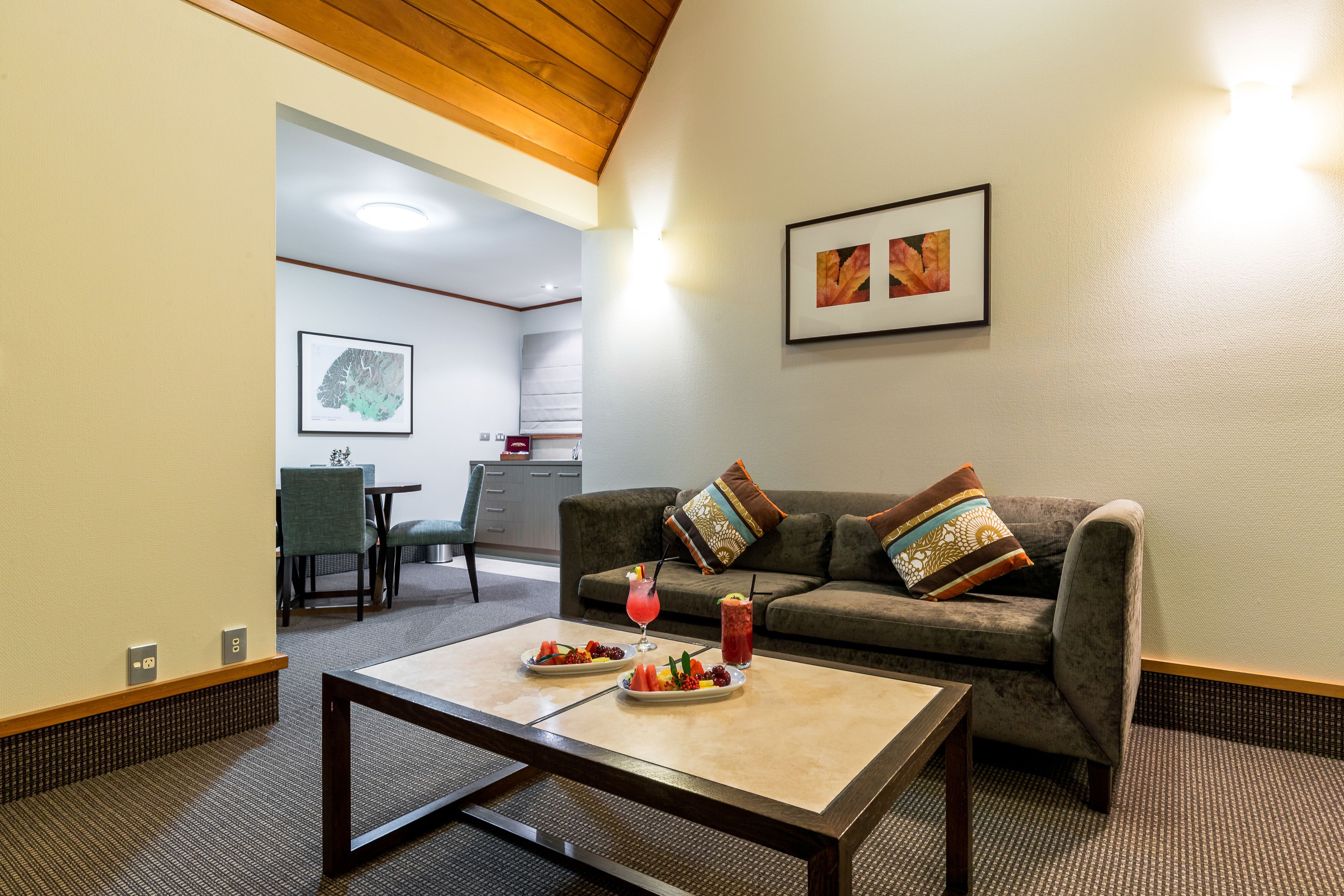 A modern living room with a sofa, coffee table, and a framed picture on the wall.