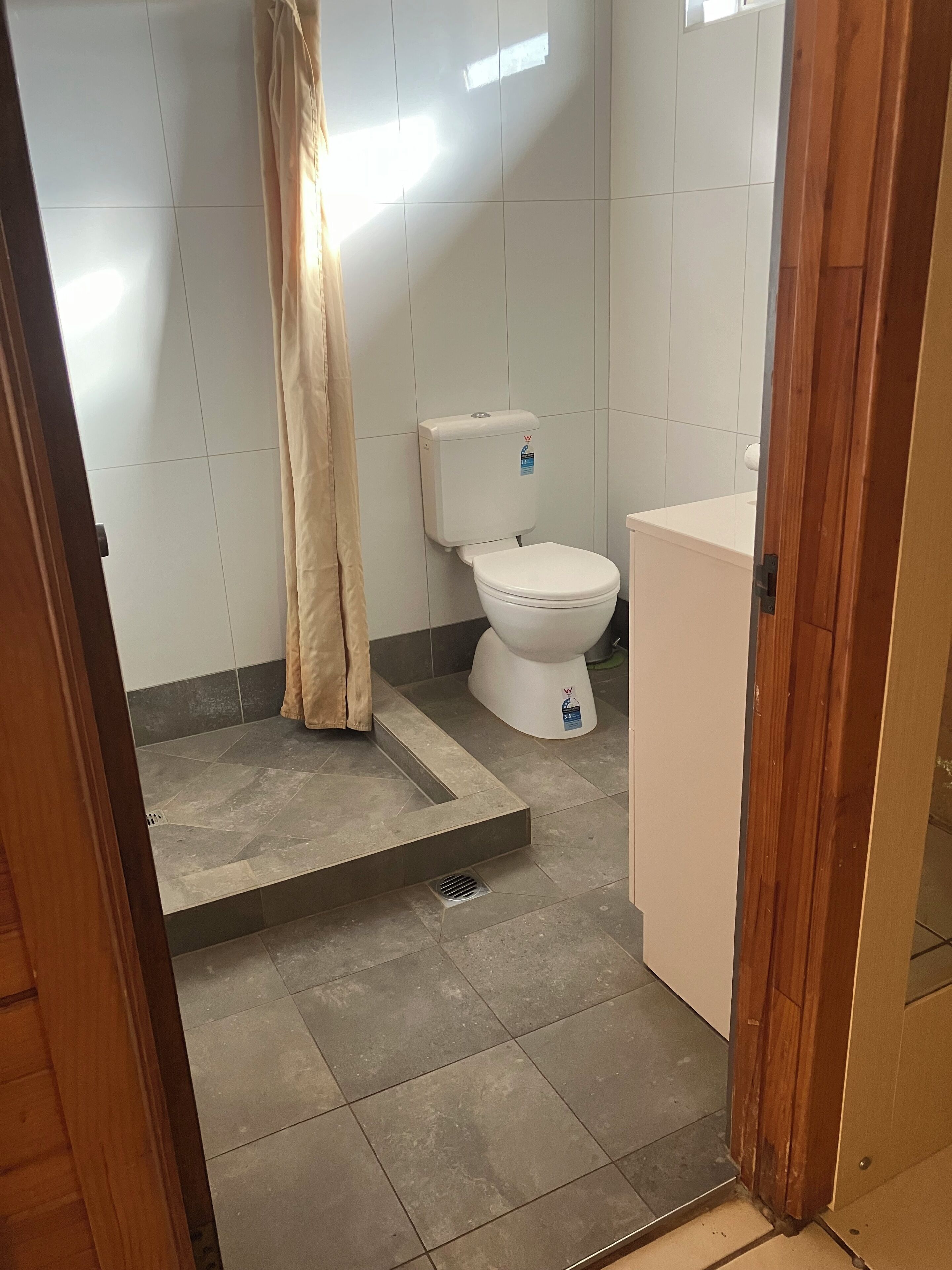 Ein Badezimmer mit Toilette, Duschvorhang und Waschbecken.