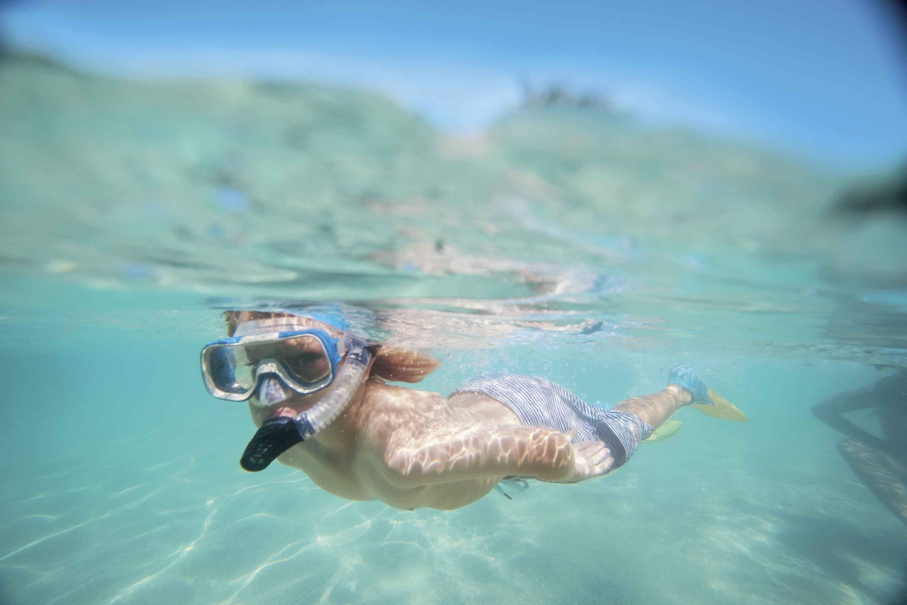 A person snorkeling underwater.