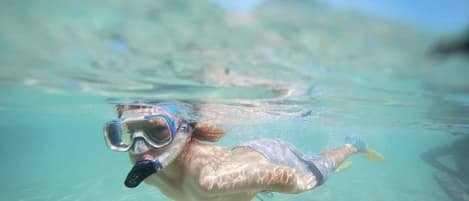 A person snorkeling underwater.