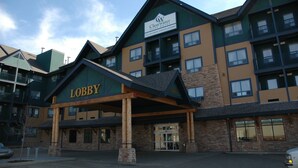 A multi-story hotel with a prominent lobby entrance, a sign for the lobby, and a sign for the hotel named "Clearwater Suites Hotel". - Clearwater Suite Hotel (Fort McMurray)